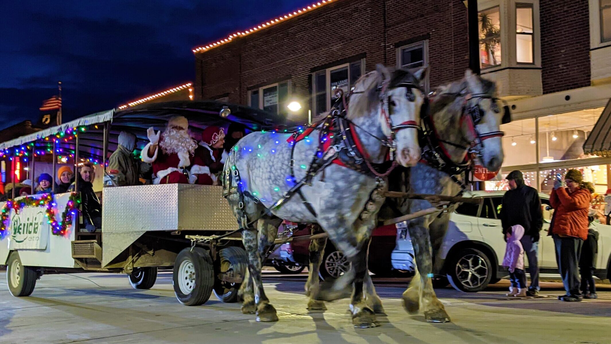 Valley Junction Santa in a horse drawn bus with people riding along