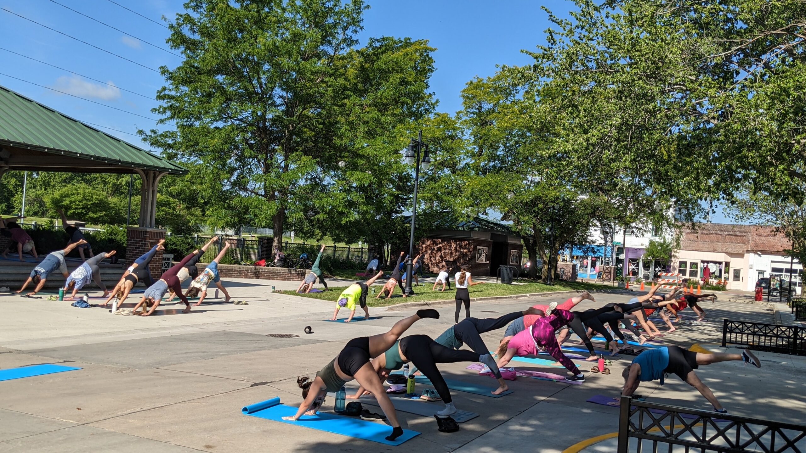 people doing yoga in railroad park during the event yoga in the park in valley junction