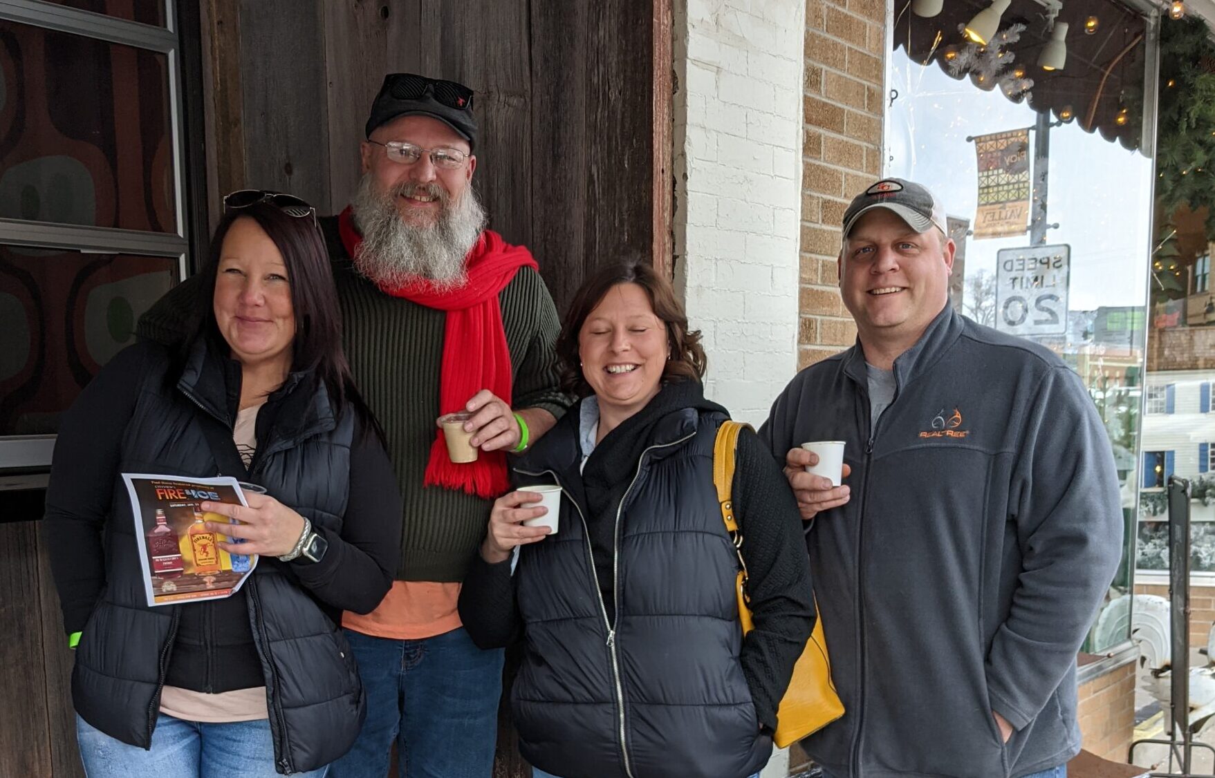 Four people drinking outside of a bar at fire & ice pub crawl