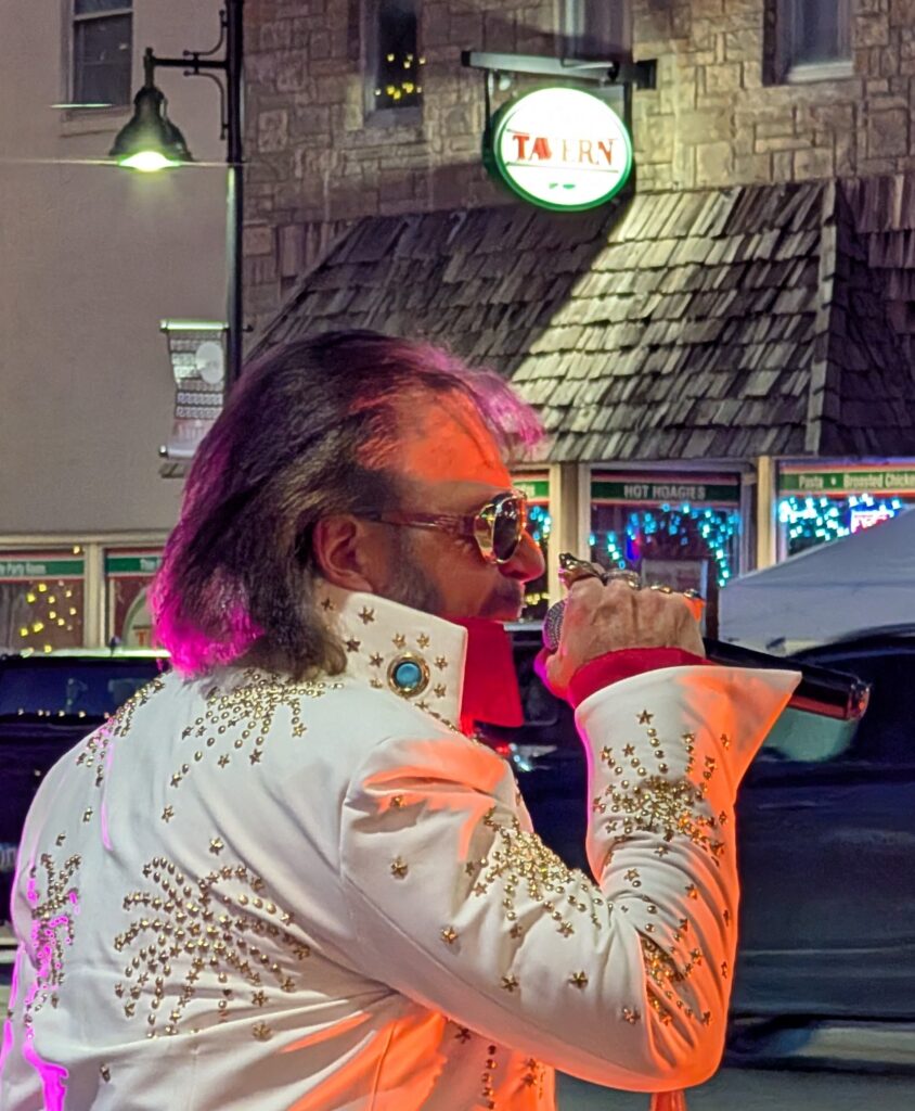 elvis incognito performing in front of the Tavern at Jingle in the Junction