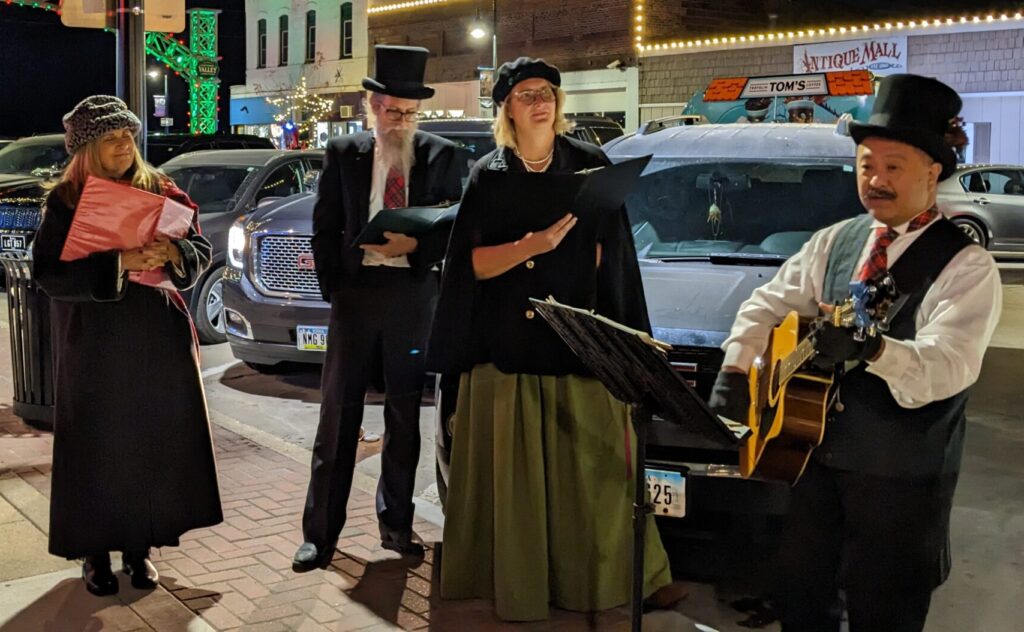 top hat carolers performing at jingle in the junction